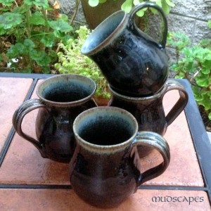 Black mugs with a bit of blue on the rim - Mudscapes by Kathy Booker